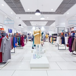 clothing store front with racks of clothes and mannequins