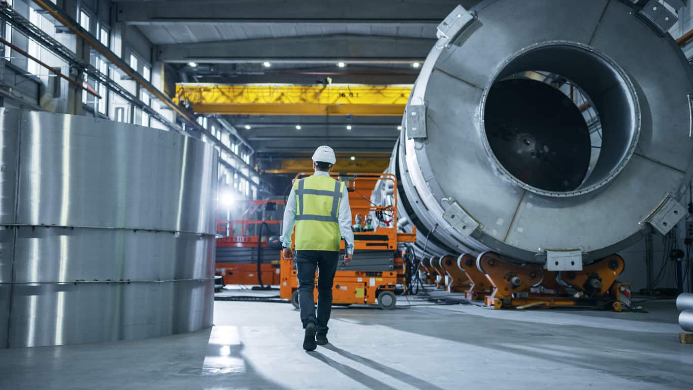 Engineer walking oil and gas facility